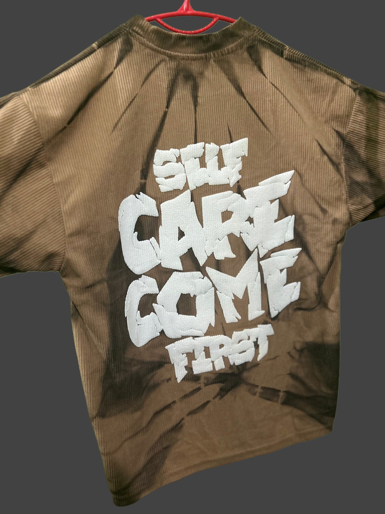 brown tie-dye t-shirt with a bold